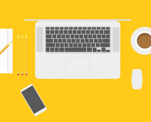 Grafik mit Computertastatur 3 Bleistiften daneben, einem Handy davor und einer Tasse rechts daneben